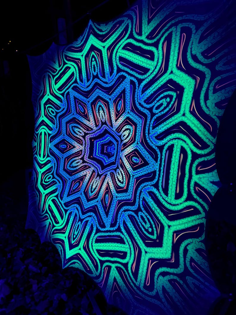 May include: A blacklight reactive tapestry with a colorful mandala design in shades of blue, green, and pink. The mandala features intricate geometric patterns and a central starburst.