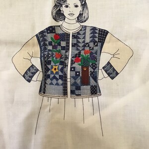 May include: A black and white line drawing of a woman wearing a blue and white patchwork vest with floral embroidery. The vest has a button closure and a pocket on the front. The text "DreamSpinners" is printed in the bottom right corner of the image.