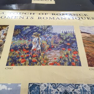 May include: A painting of a young girl in a straw hat walking through a field of red poppies. The painting is part of a collection called "A Touch of Romance, Moments Romantiques".
