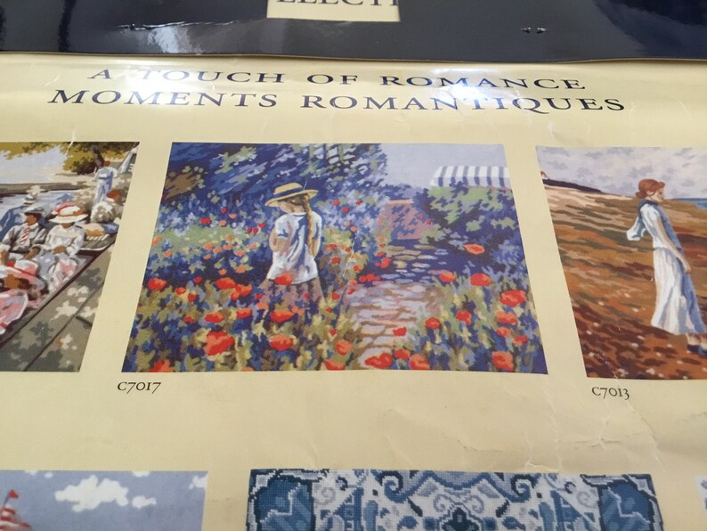 May include: A painting of a young girl in a straw hat walking through a field of red poppies. The painting is part of a collection called "A Touch of Romance, Moments Romantiques".