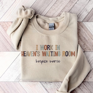 Hospice Nurse Sweatshirt | I Work in Heaven&#39;s Waiting Room Cute Shirt | Registered RN Gift | Nurse Week Appreciation Graphic Clothing Tee