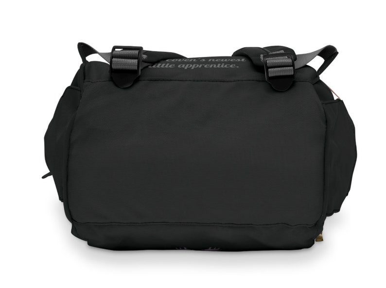 May include: Black messenger bag with two adjustable buckles and a shoulder strap. The bag has side pockets and a flap closure. The text "coven's newest little apprentice" is printed on the top of the bag.