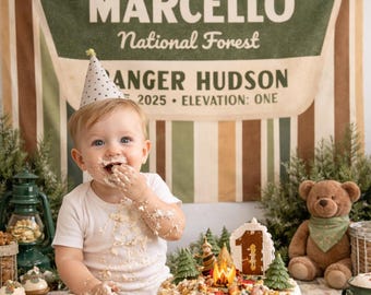May include: A white fabric banner with vertical stripes in green, brown, and cream, featuring the text Welcome to MARCELLO National Forest, RANGER HUDSON, 2025, and ELEVATION: ONE, displayed behind a child wearing a polka dot party hat.