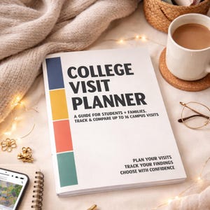 May include: A white "College Visit Planner" book with colorful vertical stripes. The book includes text: "A Guide for Students + Families. Track & Compare up to 16 Campus Visits." A mug of coffee, glasses, and a phone are also visible.