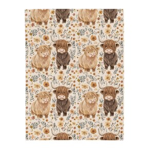 May include: A patterned textile featuring a repeating design of Highland cows in shades of brown and tan, interspersed with floral elements in yellow and green. The background is a cream color.