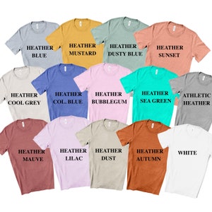 May include: A collection of fourteen short-sleeved crew neck t-shirts in various colors including heather blue, mustard, dusty blue, sunset, cool grey, col. blue, bubblegum, sea green, athletic heather, mauve, lilac, dust, autumn, and white.