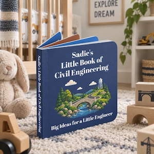 May include: A dark blue board book titled Sadie's Little Book of Civil Engineering with the subtitle Big Ideas for a Little Engineer. The cover features a colorful illustration of a stone bridge over a river, a winding road, and a water tower.