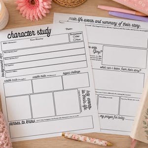 May include: A character study worksheet with the title "character study" and a Bible. The worksheet includes sections for background information, notable traits, and key events. A lit candle, a pink flower, and a pen are also visible.