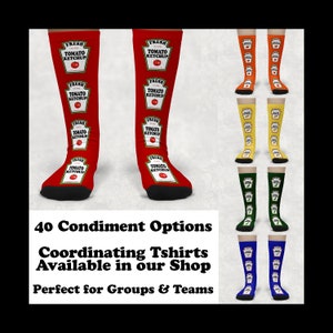 May include: A set of knee-high socks with a red, orange, yellow, green, and blue background. Each sock features a repeated pattern of a ketchup bottle with the text "Fresh Tomato Ketchup".