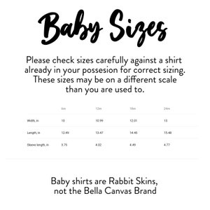 May include: White background with the text "Baby Sizes" in a cursive font. Below, size details are listed for baby shirts, including width, length, and sleeve length in inches for sizes 6m, 12m, 18m, and 24m. The text also states that the shirts are Rabbit Skins, not Bella Canvas.