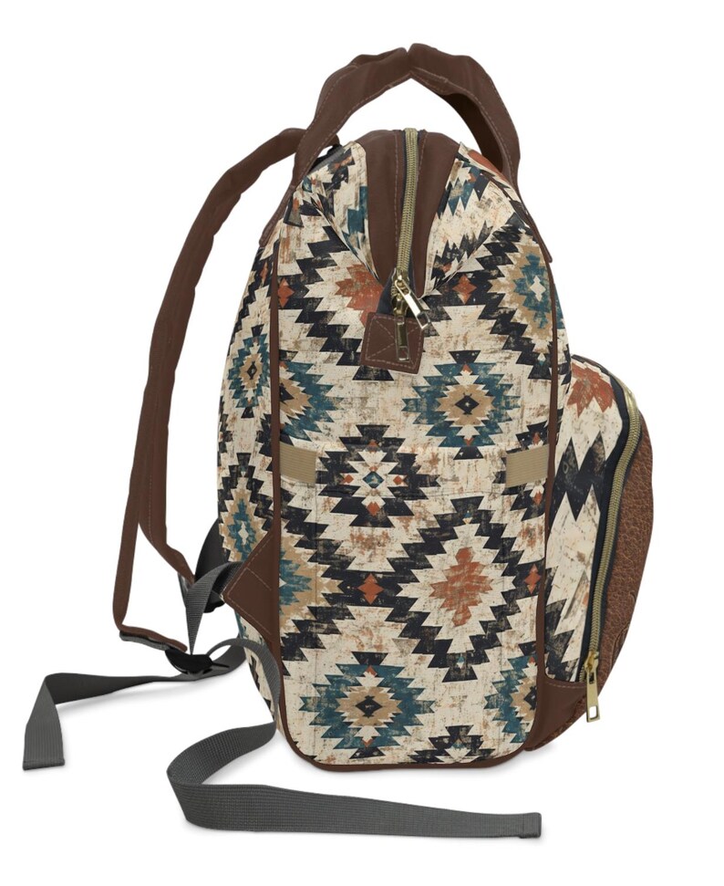May include: Backpack with a geometric pattern in shades of brown, teal, and black. The backpack has brown straps, a top handle, and a zipper closure. The bag has a side pocket and adjustable straps.