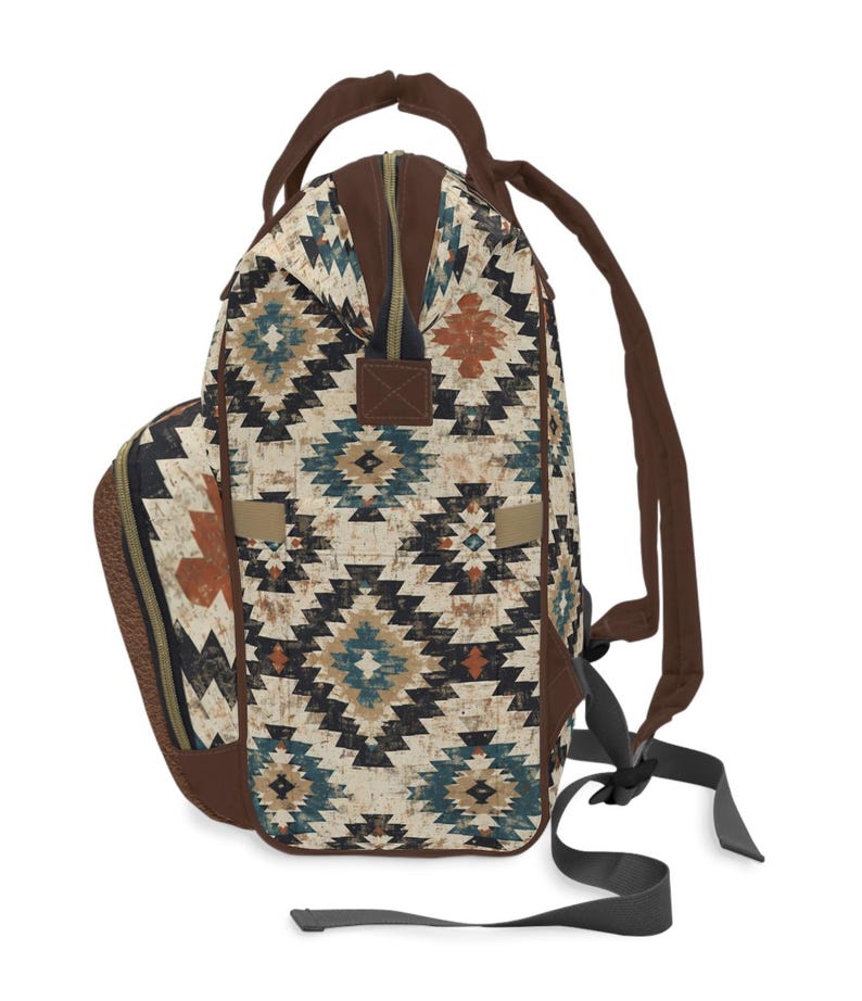 May include: A backpack with a Southwestern geometric pattern in shades of cream, brown, teal, and rust. The bag features brown straps, a top handle, and a zippered closure. The design includes a side pocket and adjustable shoulder straps.