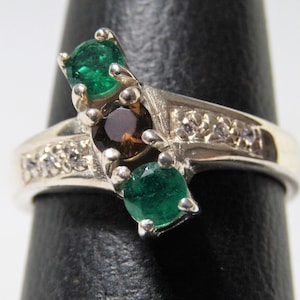 Solid sterling silver ring with two emeralds