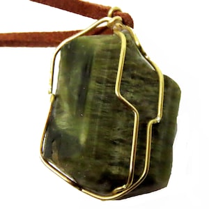 Rough green tourmaline pendant in sterling silver and leather.