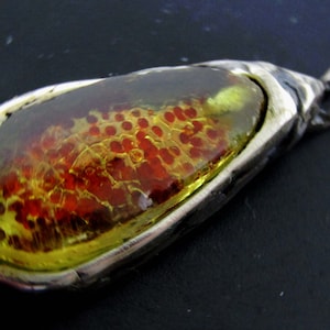 Young amber (Copal) pendant in aged silver, with embedded spores
