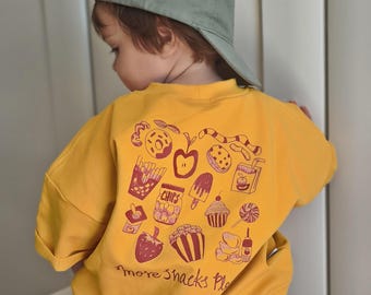 Camiseta infantil extragrande "¡Más snacks, por favor!" | en amarillo mantequilla | Camiseta de verano para bebés y niños | Tallas de la 62 a la 128 | Camiseta con estampado en la espalda