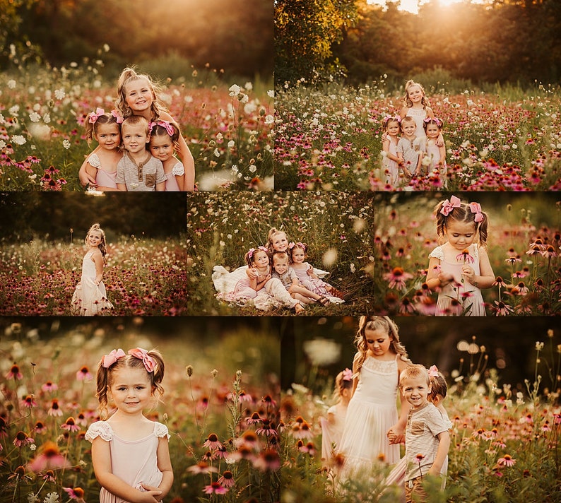 May include: A group of children in pink dresses and white shirts pose in a field of pink and white wildflowers. The children are smiling and looking at the camera. The field is full of wildflowers and the sun is shining.