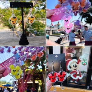 May include: Clear acrylic earrings featuring Mickey Mouse designs in various colors, including orange, yellow, and red. The earrings are shaped like balloons and have a silver-colored hook. Some earrings have a black backing.