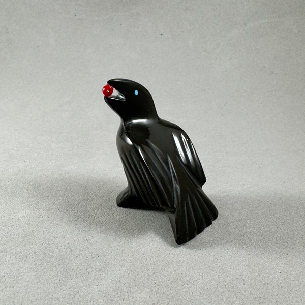 Zuni fetish raven with berry in its mouth, handmade by artist Calvert Bowannie, black marble with turquoise eyes and coral berry