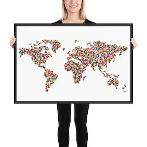 May include: A framed world map made of colorful round beads. The map is on a white background and is framed in black.