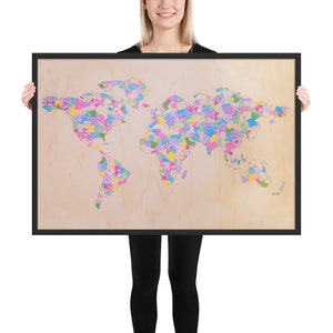 May include: A framed world map print with a colorful patchwork design. The map is made up of small squares of different colors and patterns, creating a unique and eye-catching design.