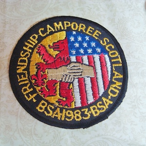 May include: A handmade wooden sign with the text "Welcome" in a handwritten style. The sign is painted white with a distressed finish and features a small, decorative heart. It is designed for indoor or outdoor use.