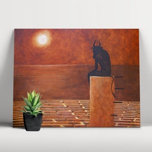 May include: An abstract painting shows a dark silhouette of a bull-like figure seated on a rectangular structure, overlooking a maze. The background features a sunset with a bright sun. A small potted plant sits in front of the painting.