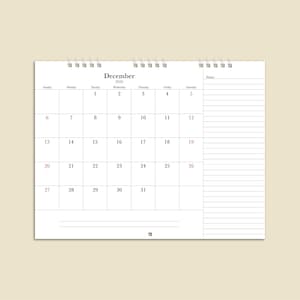 May include: A white desk calendar for December 2026, with a spiral binding at the top. The calendar grid displays the days of the month, with Sundays and Saturdays in red. A notes section is on the right.