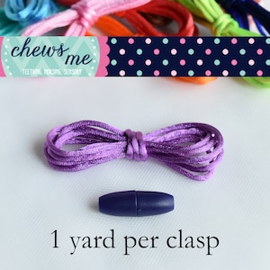 May include: A purple cord with a navy blue clasp. The cord is 1 yard long. "chews me" is written on a pink and blue banner with white polka dots.