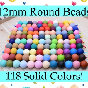 May include: A selection of 12mm round beads in 118 solid colours. Each bead is a different colour, including shades of blue, green, pink, purple, and yellow. The image includes the text "Chews Me Color Guide" and "One of each colour."
