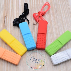 May include: Six silicone teethers in various colors, including orange, yellow, blue, green, red, and white. Each teether has a textured surface and a cord for attaching to a stroller or other object.