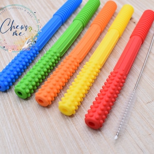 May include: Six colorful silicone straws with textured bumps and a cleaning brush. The straws are blue, green, orange, yellow, and red.  "Chews Me" is written on the background.