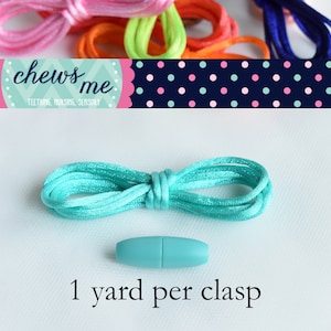 May include: A turquoise cord with a turquoise plastic clasp. The cord is 1 yard long. The text "chews me" is visible in the background. Teething, nursing, sensory.