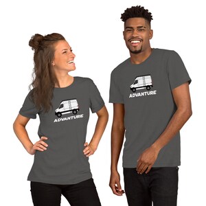 May include: Two people wearing charcoal grey t-shirts with a white silhouette of a van with a roof rack and the word "ADVANTURE" printed in white.