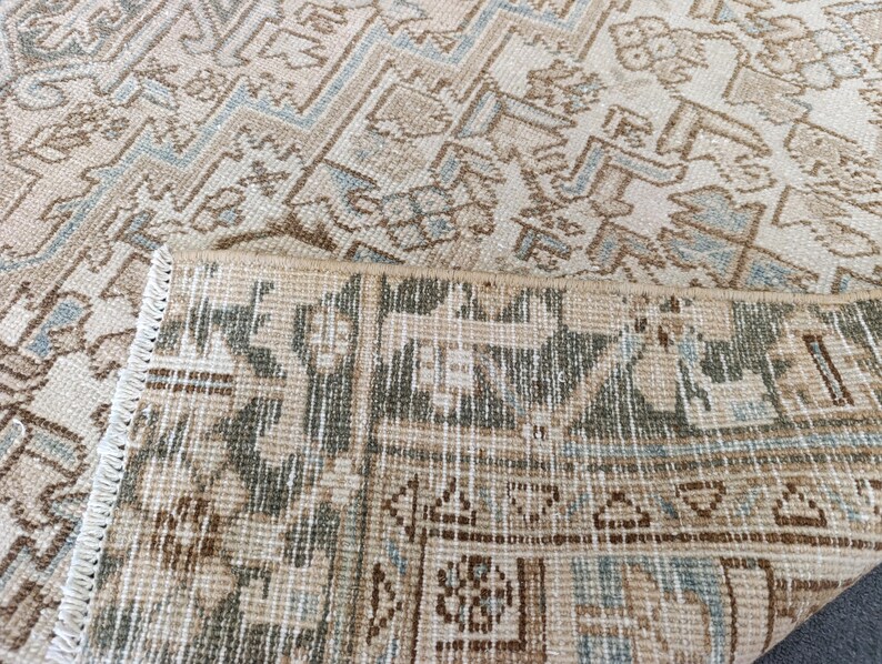 May include: Beige and brown patterned rug with a geometric design. The rug has a distressed look with a mix of light and dark brown, beige, and light blue accents. The edges are fringed.