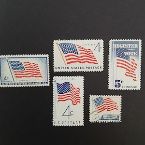 May include: A collection of vintage U.S. postage stamps featuring the American flag. The stamps display the flag waving, with text including "United States Postage", "Register Vote", and dates like "July 4, 1959" and "July 4, 1960".