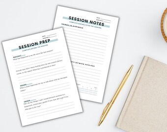 May include: Two white paper pads with teal accents, labeled "Session Prep" and "Session Notes," lie on a white surface. A gold pen and a beige notebook are next to the pads. A cup of coffee sits in the background.