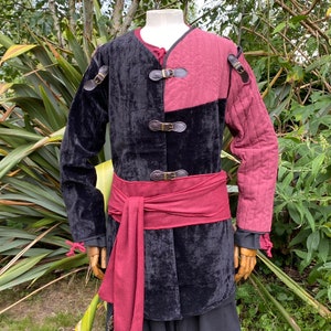 This LARP Gambeson Jacket comes in Black & Red Faux Suede. The LARP Armor has Removeable Sleeves that attach at the shoulder. The Padded Armor is warm and water resistant. This Jacket is perfect for your LARP Costume, Cosplay, and Ren Faires.