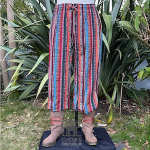 May include: Multicolored striped pants with a drawstring waist. The pants are made of a soft, comfortable fabric and have a relaxed fit.