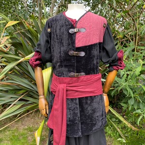 This LARP Gambeson Jacket comes in Black & Red Faux Suede. The LARP Armor has Removeable Sleeves that attach at the shoulder. The Padded Armor is warm and water resistant. This Jacket is perfect for your LARP Costume, Cosplay, and Ren Faires.