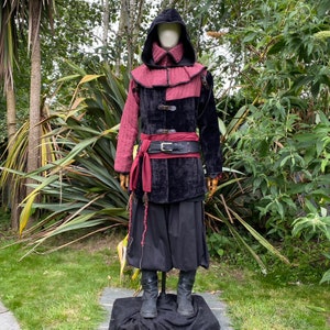 This LARP Gambeson Jacket comes in Black & Red Faux Suede. The LARP Armor has Removeable Sleeves that attach at the shoulder. The Padded Armor is warm and water resistant. This Jacket is perfect for your LARP Costume, Cosplay, and Ren Faires.