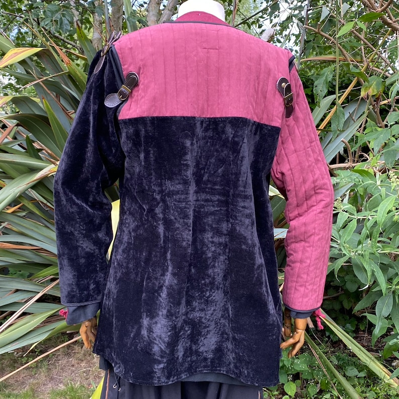 This LARP Gambeson Jacket comes in Black & Red Faux Suede. The LARP Armor has Removeable Sleeves that attach at the shoulder. The Padded Armor is warm and water resistant. This Jacket is perfect for your LARP Costume, Cosplay, and Ren Faires.
