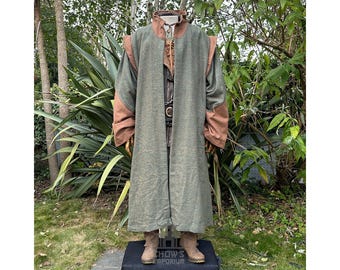 May include: A long, green and brown, hooded, medieval-style coat with brown leather accents. The coat is made of a textured fabric and has a long, flowing design.