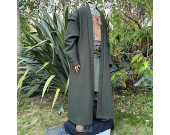 May include: A long, dark green robe with a brown belt and a brown and white patterned undergarment. The robe has a collar and long sleeves.