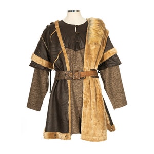 Barbarian Master 3-Piece Set – Perfect for Fighter, Warlock, and Assassin characters in LARP, Cosplay, and Ren Faire events. Includes: Faux Fur & Leather Waistcoat, Ornate Hood, and Faux Fur Vambraces with foam Throwing Dagger.