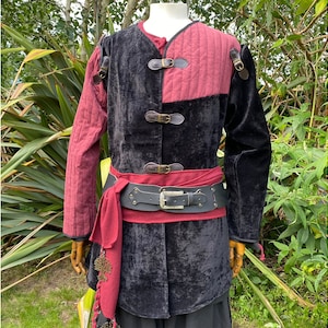 This LARP Gambeson Jacket comes in Black & Red Faux Suede. The LARP Armor has Removeable Sleeves that attach at the shoulder. The Padded Armor is warm and water resistant. This Jacket is perfect for your LARP Costume, Cosplay, and Ren Faires.