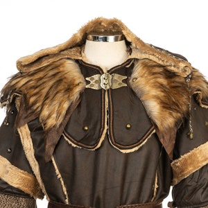 Barbarian Master 3-Piece Set – Perfect for Fighter, Warlock, and Assassin characters in LARP, Cosplay, and Ren Faire events. Includes: Faux Fur & Leather Waistcoat, Ornate Hood, and Faux Fur Vambraces with foam Throwing Dagger.
