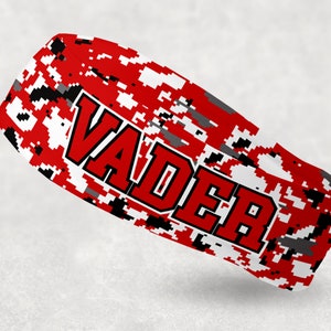 May include: A red, white, and black camouflage pattern with the word "VADER" in red letters.