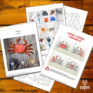 May include: A printable papercraft model of a red crab. The model is made up of geometric shapes and can be assembled into a 3D sculpture. The instructions for assembling the model are included on the page. The page also includes a logo for the company Ecogami.