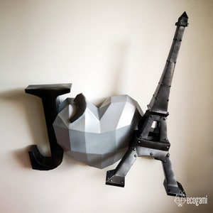 May include: A black paper mache letter J, a silver paper mache heart, and a black paper mache Eiffel Tower.